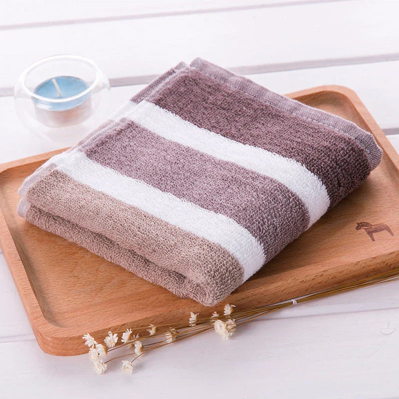 Luxurious cotton bath and face towel with brown, white, and blue striped design