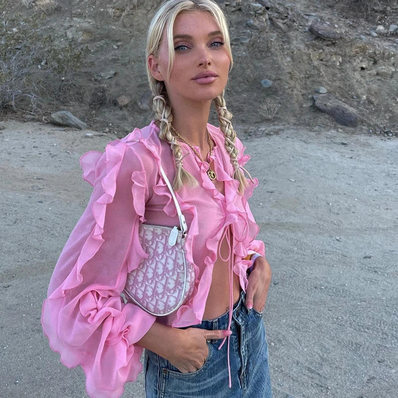 A girls' short top with a v-neck, ruffled trim, and a heart-shaped bow tie, made from stretchy chiffon fabric