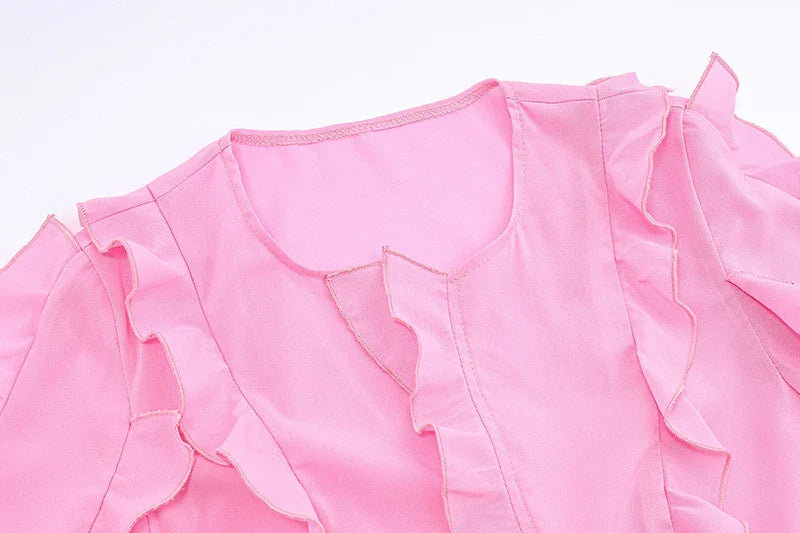 A girls' short top with a v-neck, ruffled trim, and a heart-shaped bow tie, made from stretchy chiffon fabric