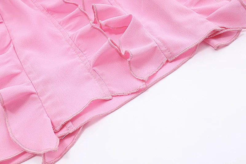 A girls' short top with a v-neck, ruffled trim, and a heart-shaped bow tie, made from stretchy chiffon fabric