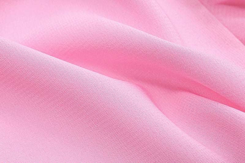 A girls' short top with a v-neck, ruffled trim, and a heart-shaped bow tie, made from stretchy chiffon fabric