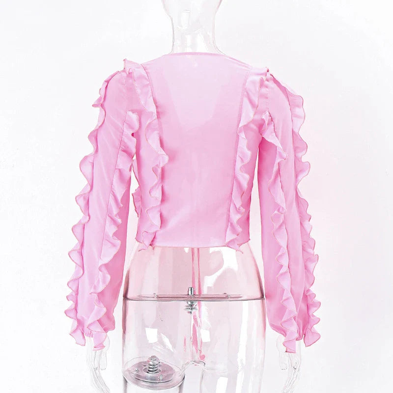 A girls' short top with a v-neck, ruffled trim, and a heart-shaped bow tie, made from stretchy chiffon fabric