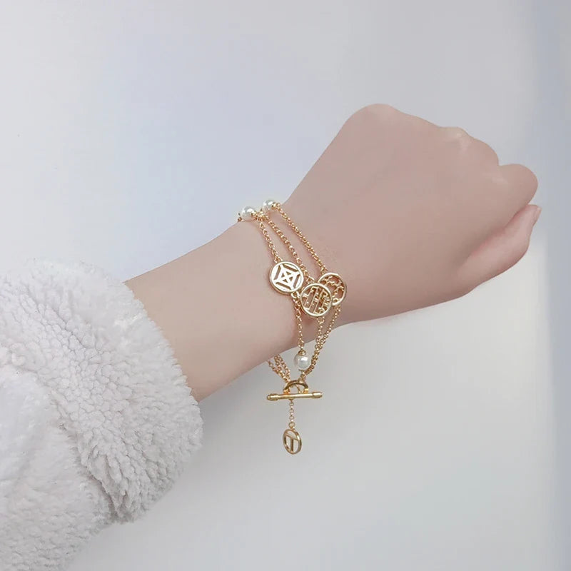 Elegant double hollow bracelet with a captivating cross, crown, or Roman numeral pattern, crafted with premium plated alloy materials.