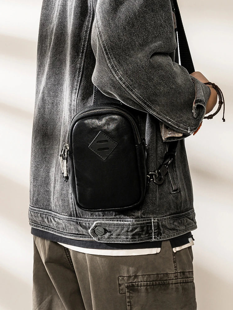 Stylish black leather chest bag with adjustable strap for modern urban gentlemen