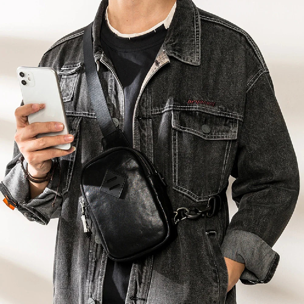Stylish black leather chest bag with adjustable strap for modern urban gentlemen
