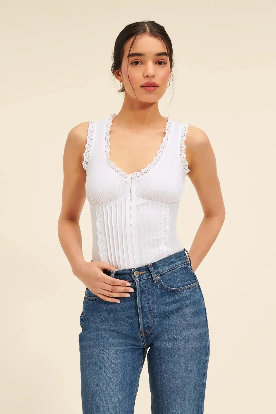 Elegant white tank top with embroidered lace detailing and a sweet U-collar neckline, perfect for British-inspired casual and formal wear.