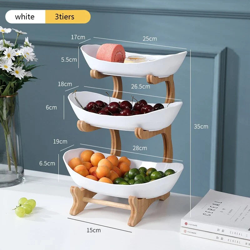 Partitioned oval table plates and fruit bowl with tiered candy and cake trays in beige