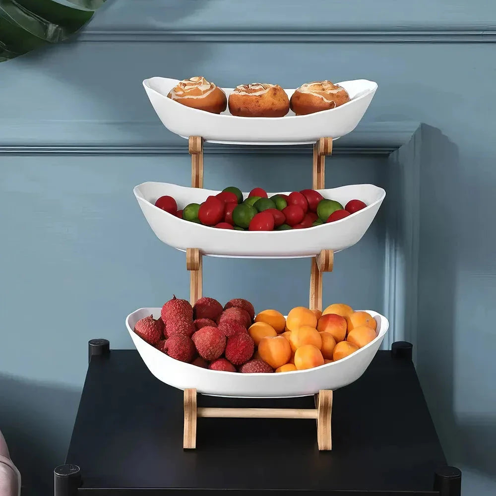 Partitioned oval table plates and fruit bowl with tiered candy and cake trays in beige