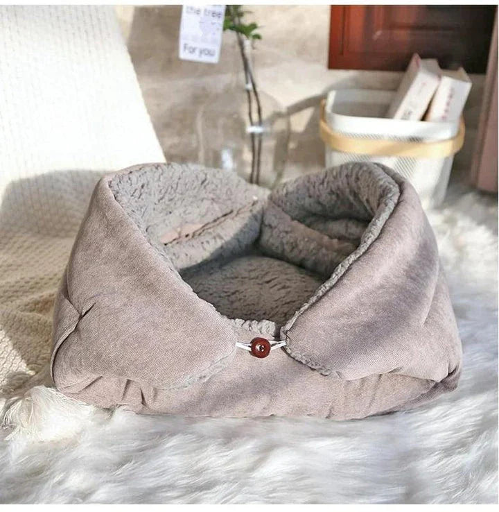 Cosy winter cat bed in plush brown fabric with a charming cartoon design, providing a warm and comfortable retreat for feline companions.
