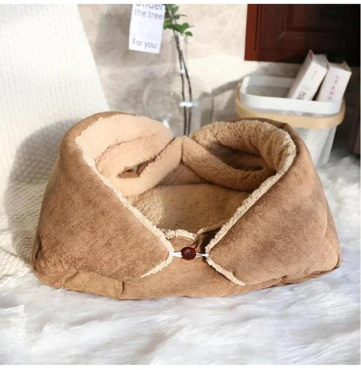 Cosy winter cat bed in plush brown fabric with a charming cartoon design, providing a warm and comfortable retreat for feline companions.