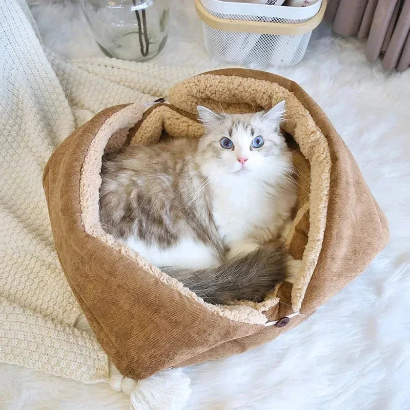 Cosy winter cat bed in plush brown fabric with a charming cartoon design, providing a warm and comfortable retreat for feline companions.