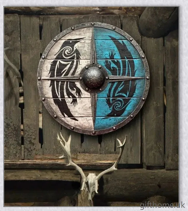 Authentic battle-worn Viking shield with two ravens design and iron spikes, adorned with Celtic buckle and rune characters