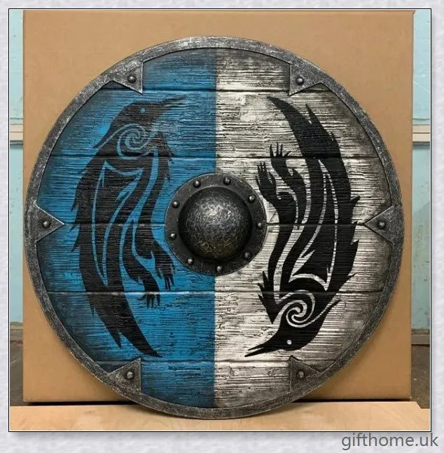 Authentic battle-worn Viking shield with two ravens design and iron spikes, adorned with Celtic buckle and rune characters