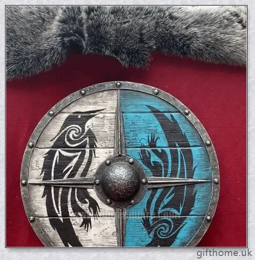 Authentic battle-worn Viking shield with two ravens design and iron spikes, adorned with Celtic buckle and rune characters