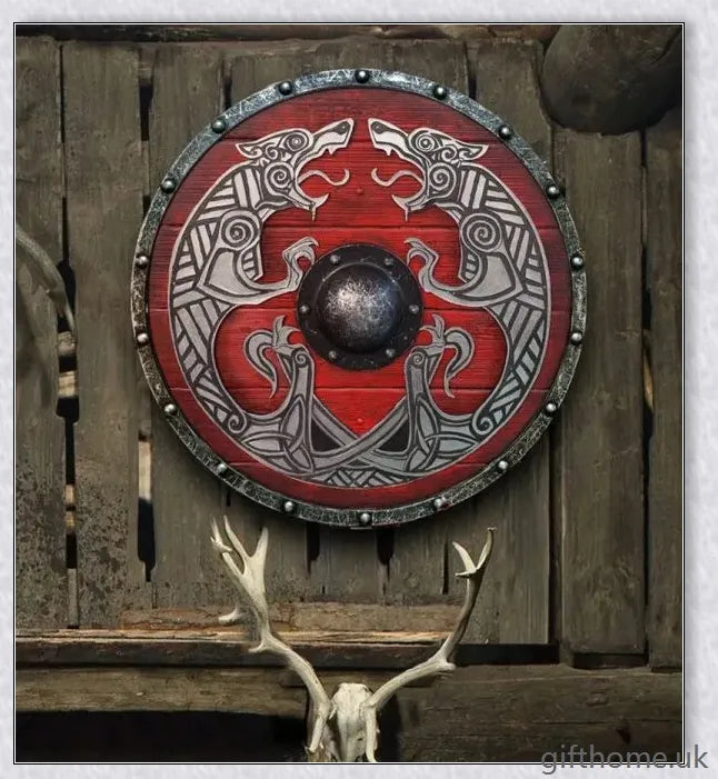 Authentic battle-worn Viking shield with two ravens design and iron spikes, adorned with Celtic buckle and rune characters
