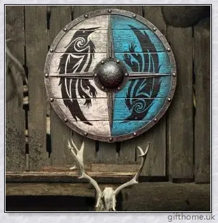 Authentic battle-worn Viking shield with two ravens design and iron spikes, adorned with Celtic buckle and rune characters
