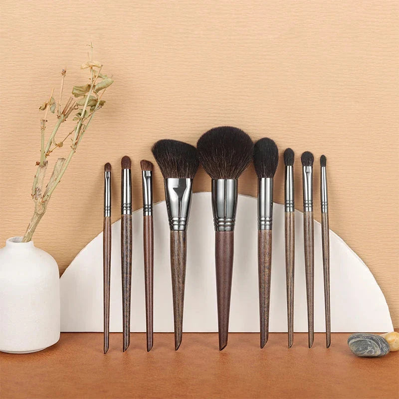 A set of 9 premium makeup brushes with soft goat hair bristles and natural wood handles, designed for flawless makeup application.