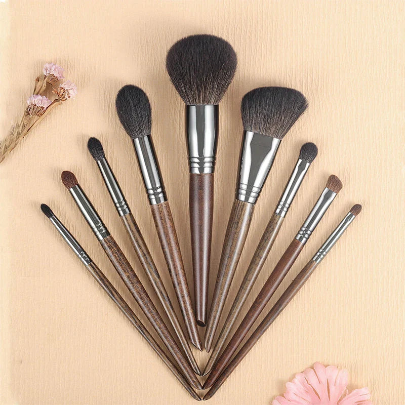 A set of 9 premium makeup brushes with soft goat hair bristles and natural wood handles, designed for flawless makeup application.