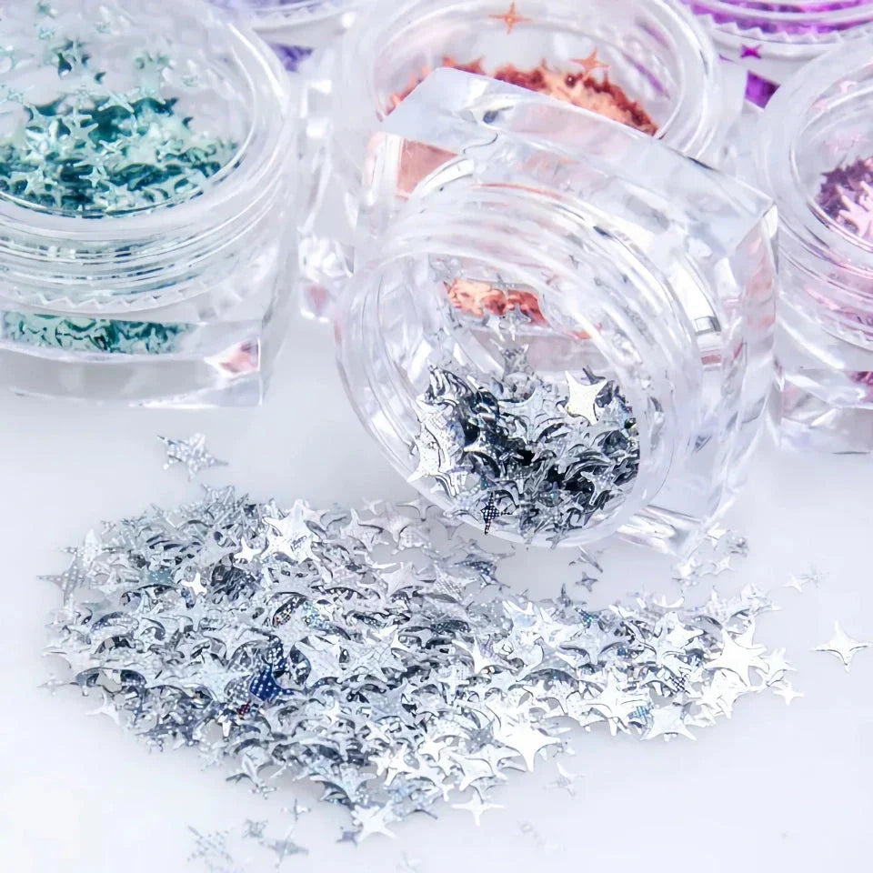 12 vibrant glitter star-shaped nail art sequins in a variety of eye-catching colours