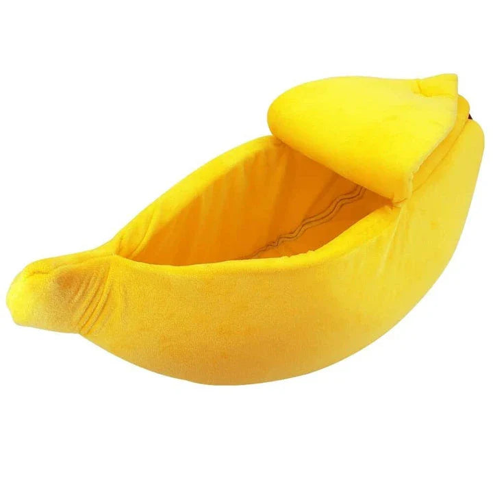Cosy banana-shaped bed for cats in bright yellow colour, providing a comfortable and stylish resting spot for felines.