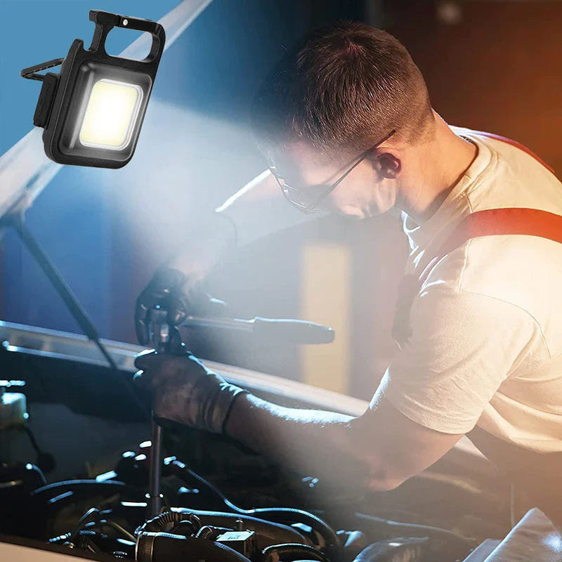 Powerful USB-rechargeable keychain flashlight with three lighting modes, magnetic base, and foldable handle for outdoor and emergency use