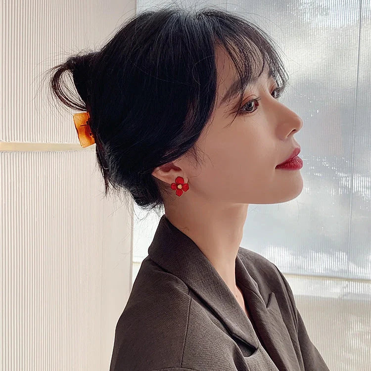 Elegant silver earrings with delicate red petal design inspired by Korean fashion