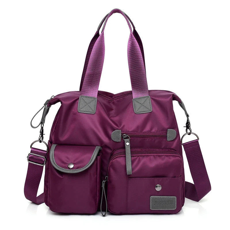 Versatile ladies shoulder bag with multiple carry options, numerous pockets, and durable Oxford fabric construction
