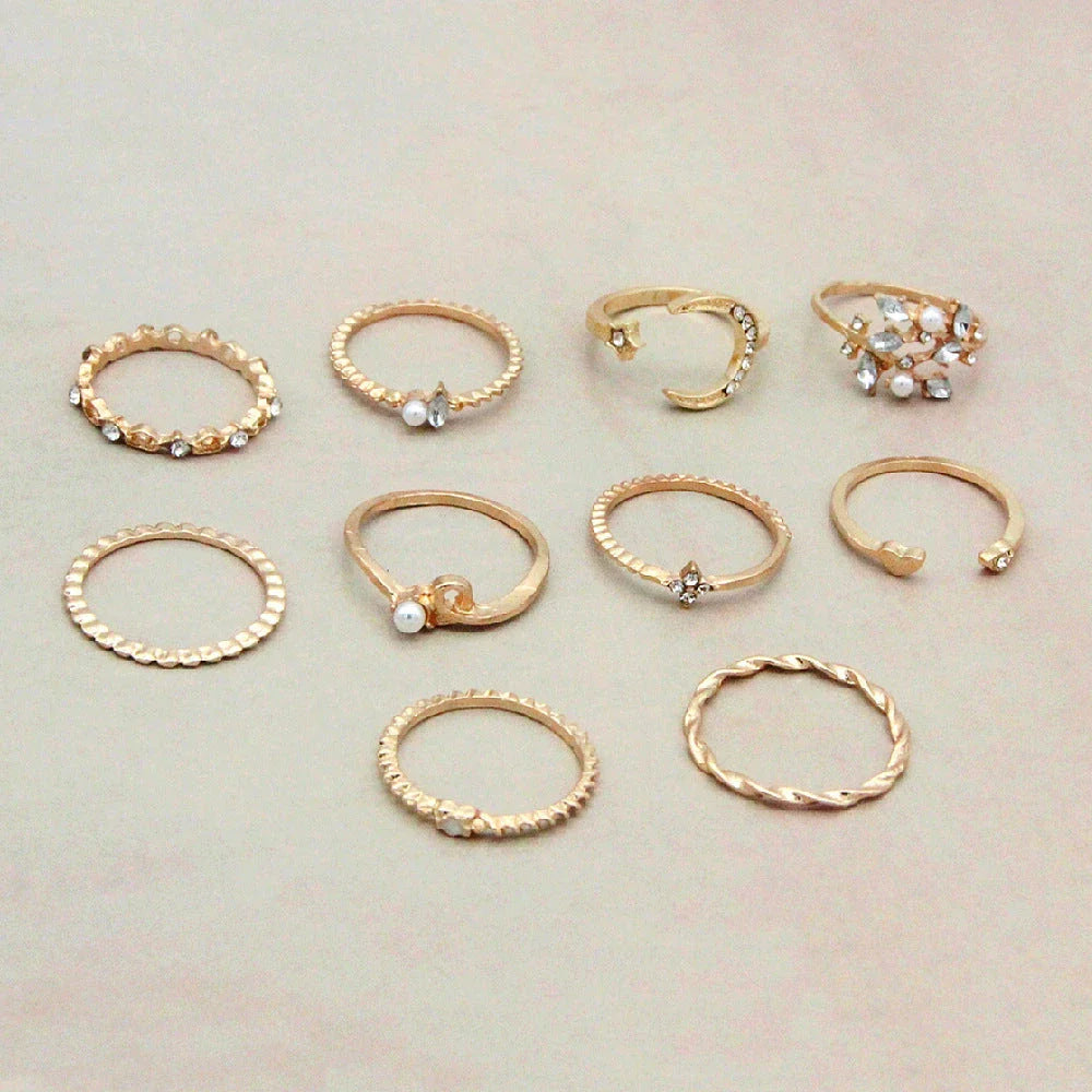 A set of 10 adjustable gold-plated rings with celestial-inspired designs including moons, stars, and pearls