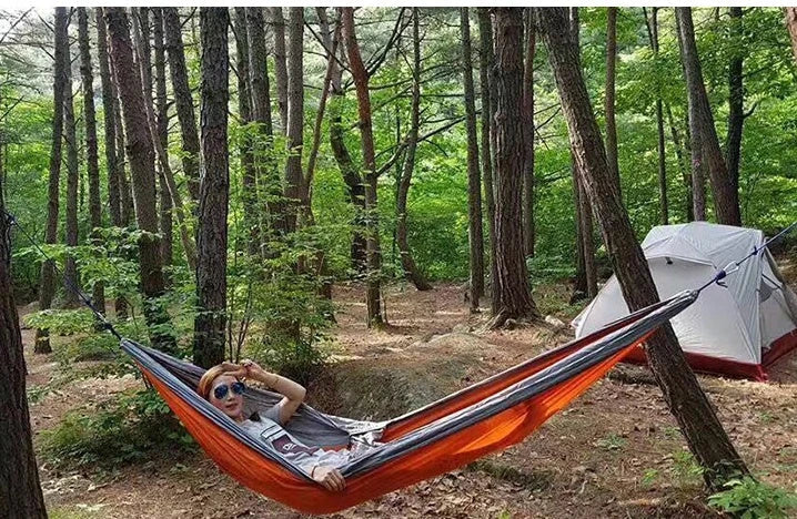 Premium double hammock for outdoor camping and hunting, made with soft, breathable fabric and reinforced climbing ropes