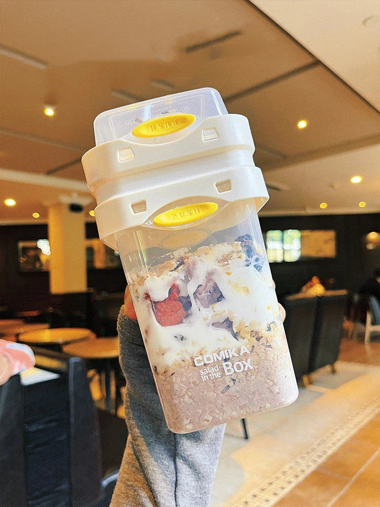 Dual-layer meal prep container with separate compartments and leak-proof lid, available in yellow and cream white colors