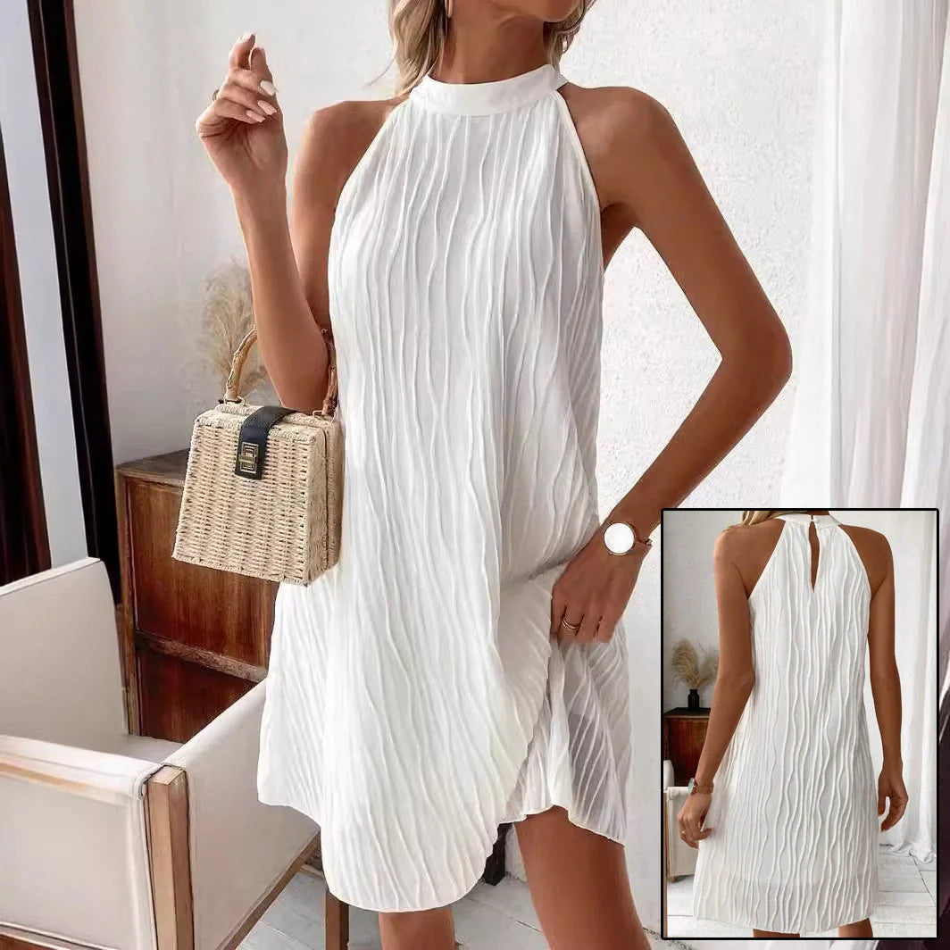 Elegant white backless halter dress with a flattering silhouette and mid-length hemline