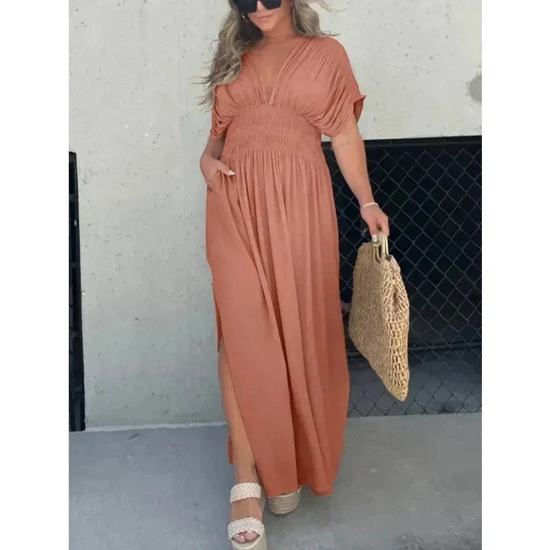 Chic bat-sleeve dress with v-neck, side slit, and elastic waist for comfortable summer style