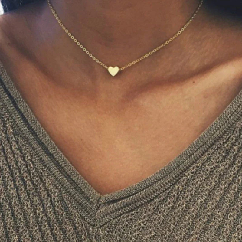 Elegant gold-tone double-sided love pendant necklace with a sleek clavicle chain design