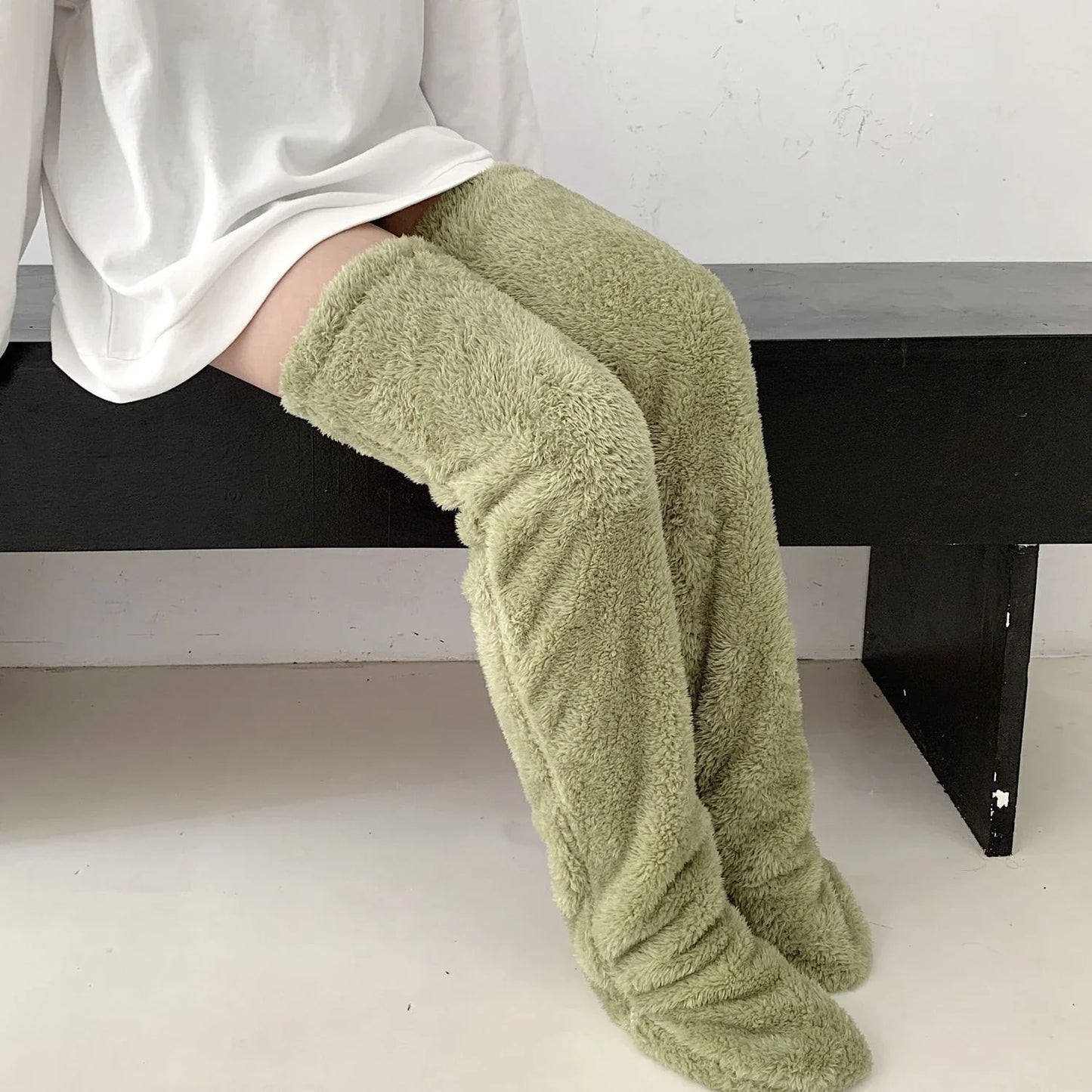 Cozy over-the-knee fuzzy socks in various colors, including brown, blue, dark gray, and pink purple