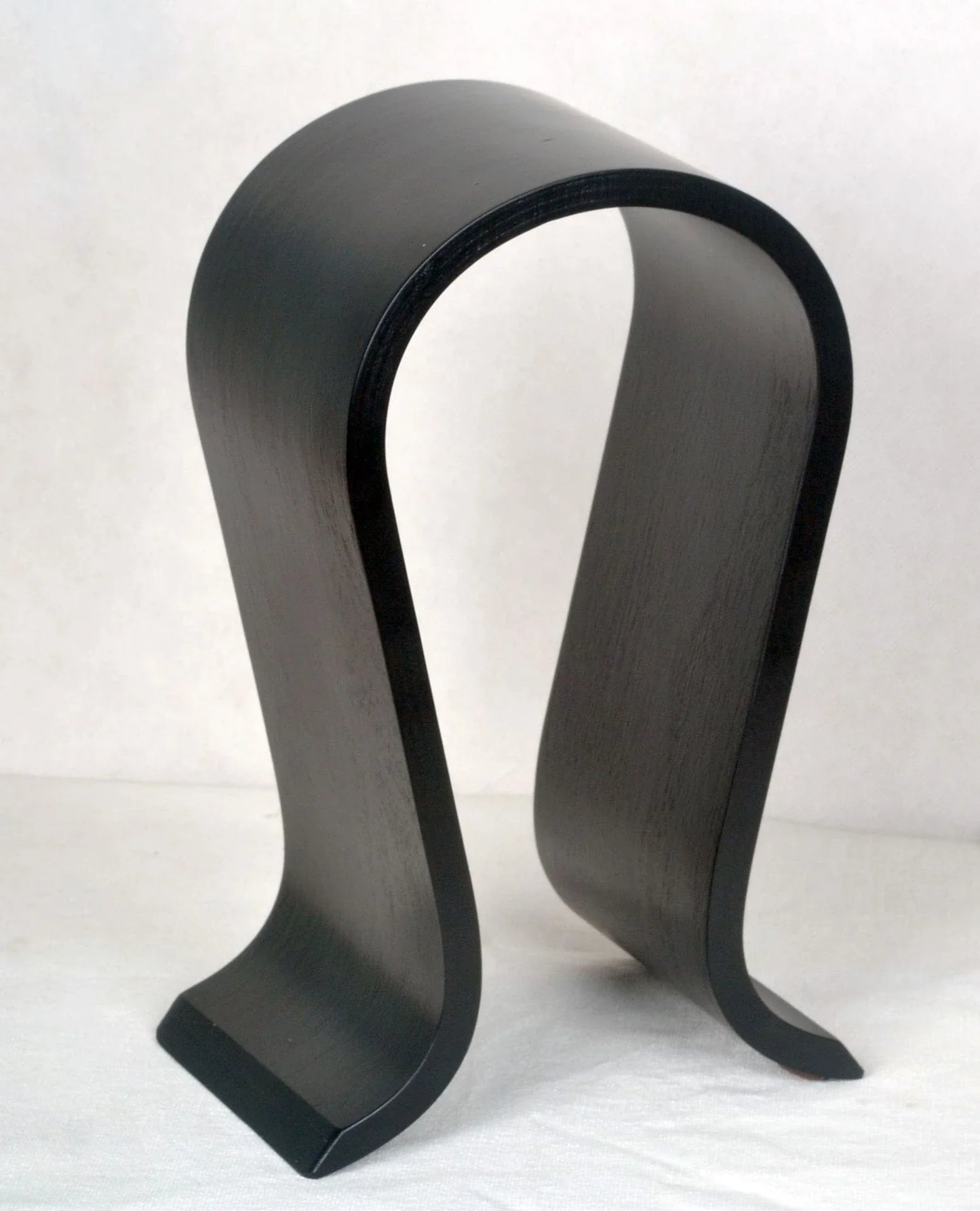 Elegant solid wood headphone stand in a contemporary design for beautiful display of audio equipment