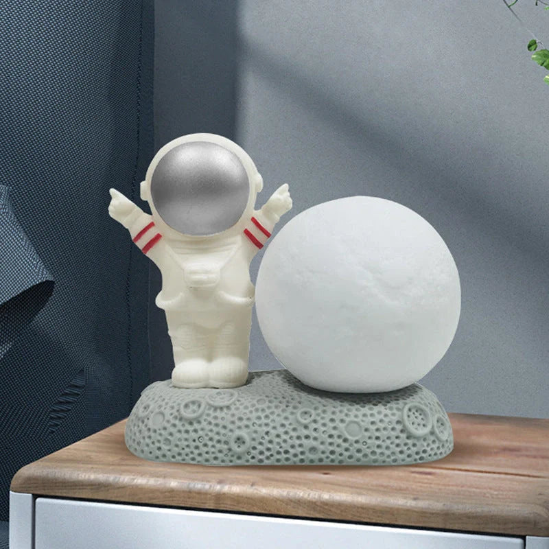 Astronaut-themed colour-changing night lamp with durable natural resin construction