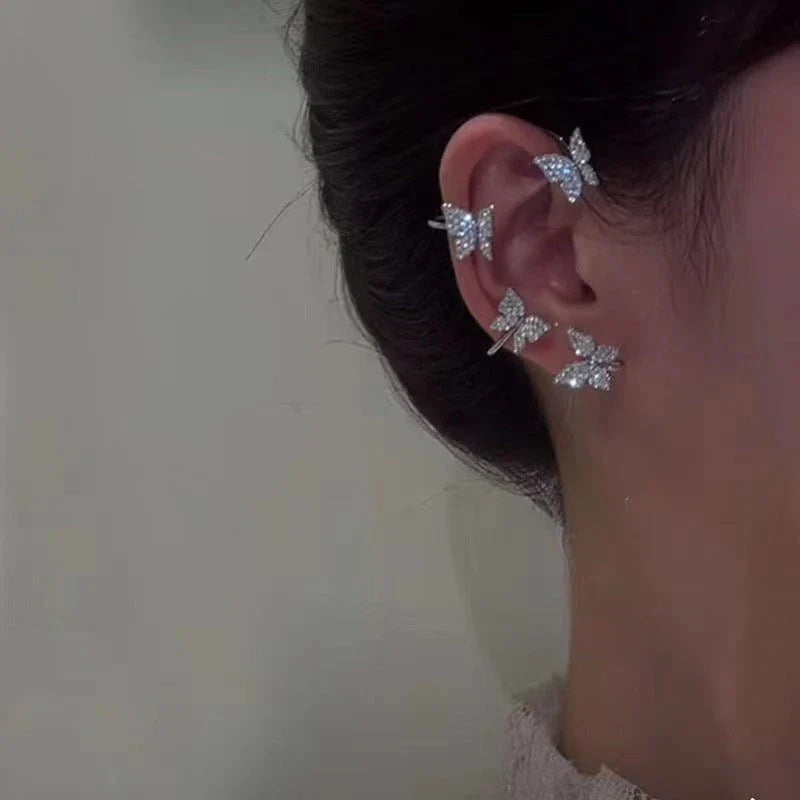 Chic butterfly ear clips in gold and silver tones, featuring a unique and elegant design for fashion-forward style.