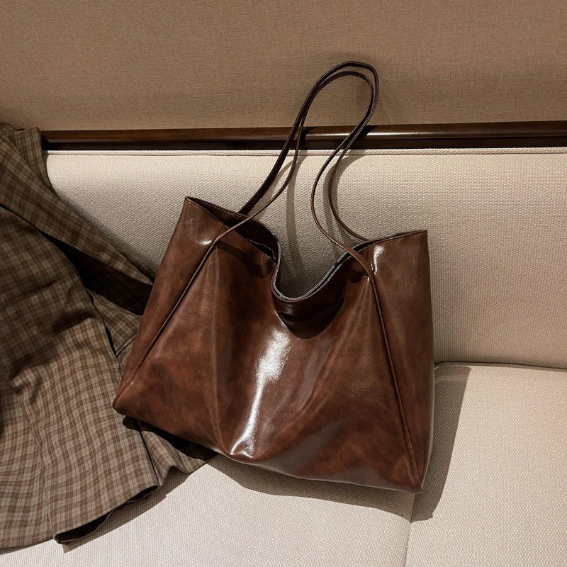 Premium faux leather shoulder bag in various colors, featuring a classic silhouette and roomy interior for everyday convenience.