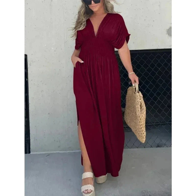 Chic bat-sleeve dress with v-neck, side slit, and elastic waist for comfortable summer style