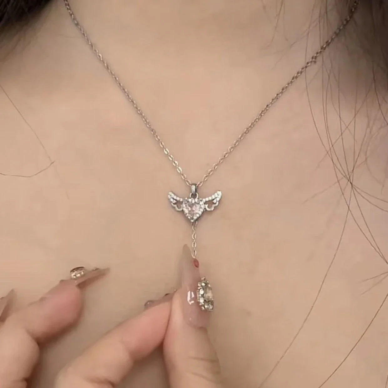 Enchanting necklace with Cupid heart and fluttering angel wings, crafted with titanium steel and sparkling zircon crystals