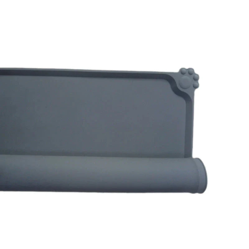 Spill-proof pet food mat made of durable silicone with non-slip base and raised edges to prevent messes