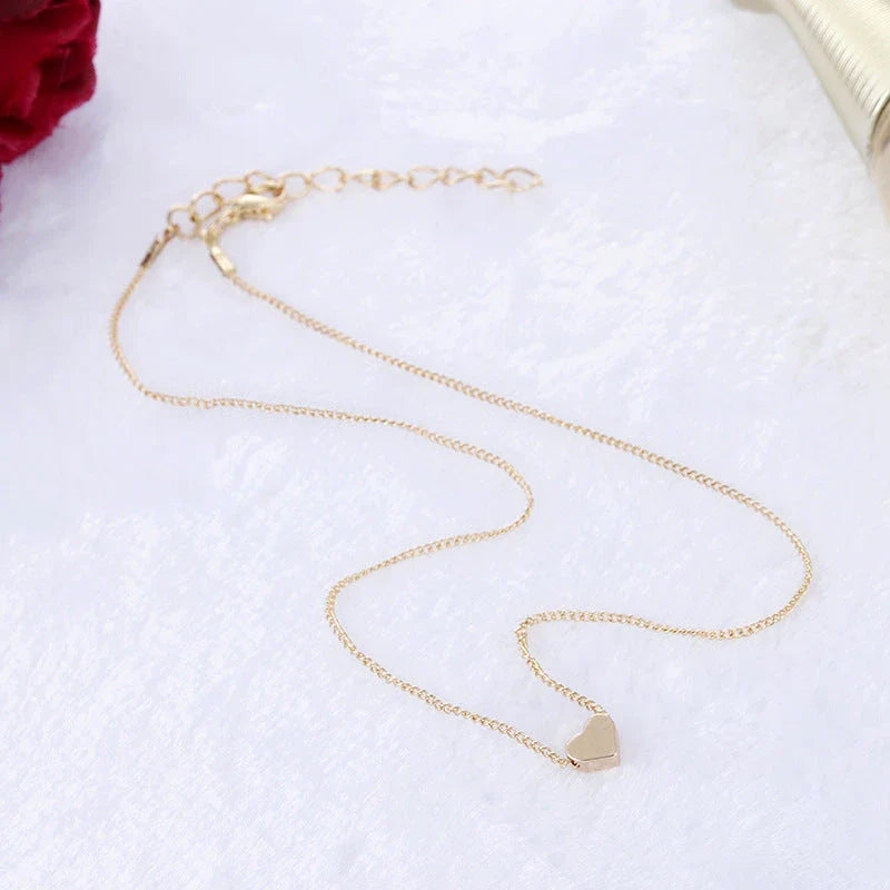 Elegant gold-tone double-sided love pendant necklace with a sleek clavicle chain design