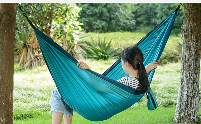Premium double hammock for outdoor camping and hunting, made with soft, breathable fabric and reinforced climbing ropes