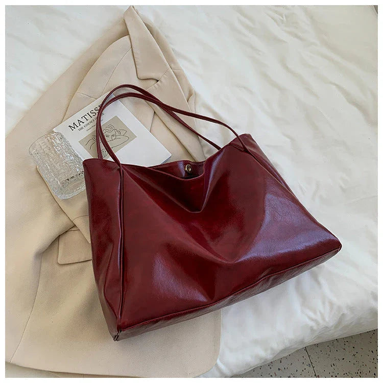 Premium faux leather shoulder bag in various colors, featuring a classic silhouette and roomy interior for everyday convenience.