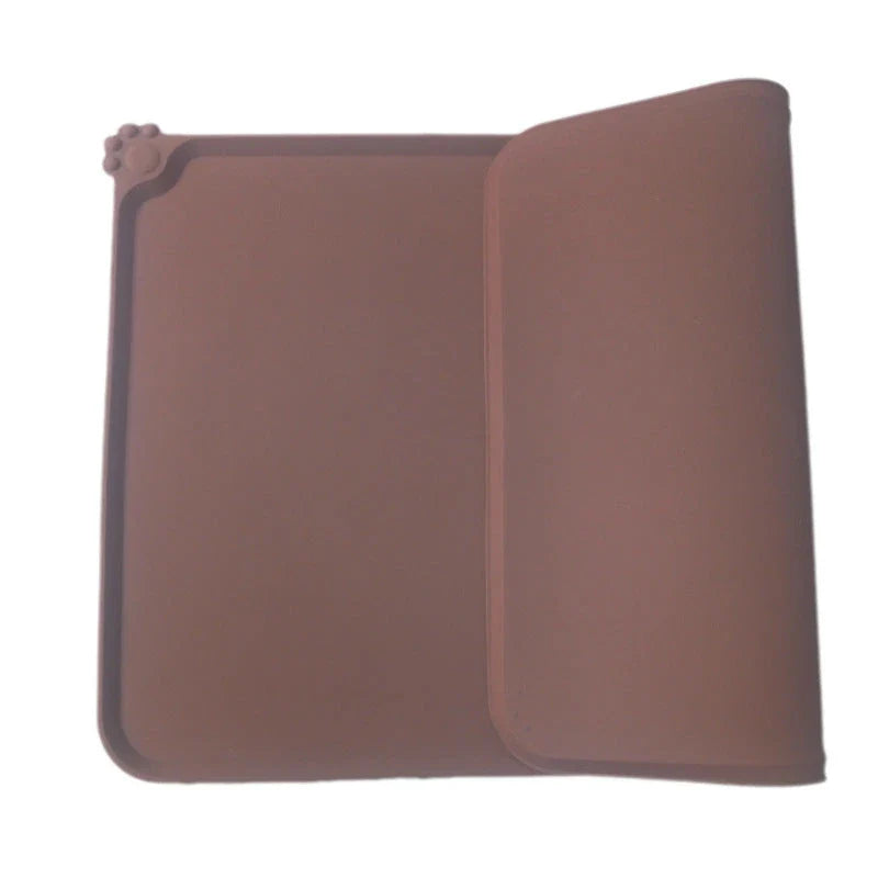 Spill-proof pet food mat made of durable silicone with non-slip base and raised edges to prevent messes