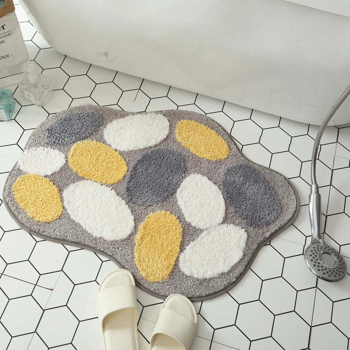 Quirky egg-shaped entrance mat made of absorbent polyester fabric with non-slip rubber backing, available in various sizes and colours