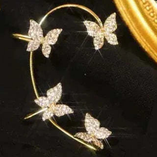 Chic butterfly ear clips in gold and silver tones, featuring a unique and elegant design for fashion-forward style.