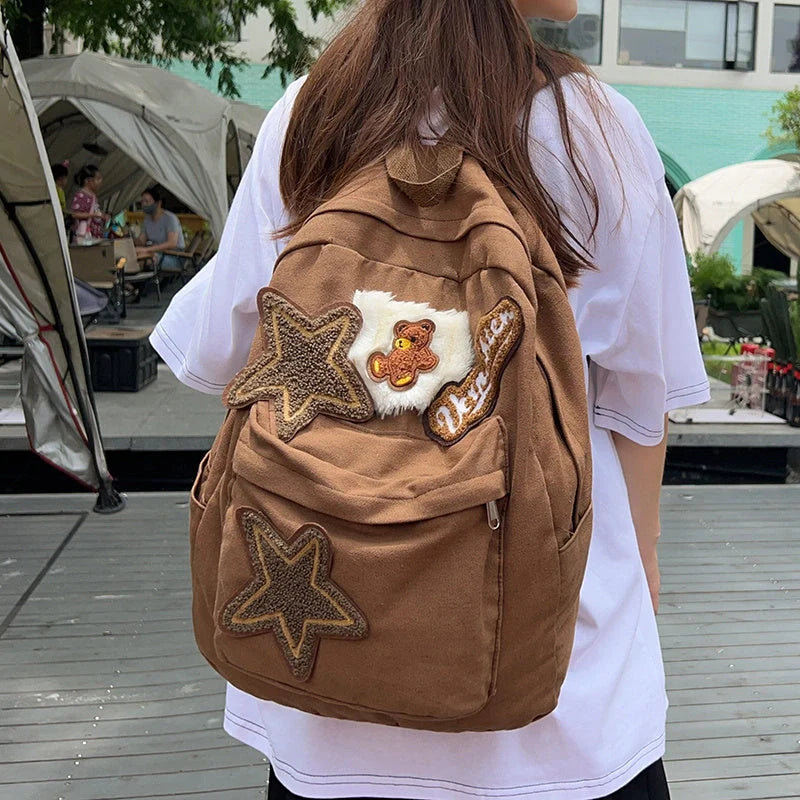 A stylish and durable canvas backpack with geometric patterns, designed for female college students