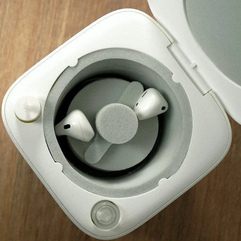Automatic earbuds cleaning kit for AirPods, featuring a specialized chamber and cleaning mechanisms to thoroughly remove dirt and wax buildup
