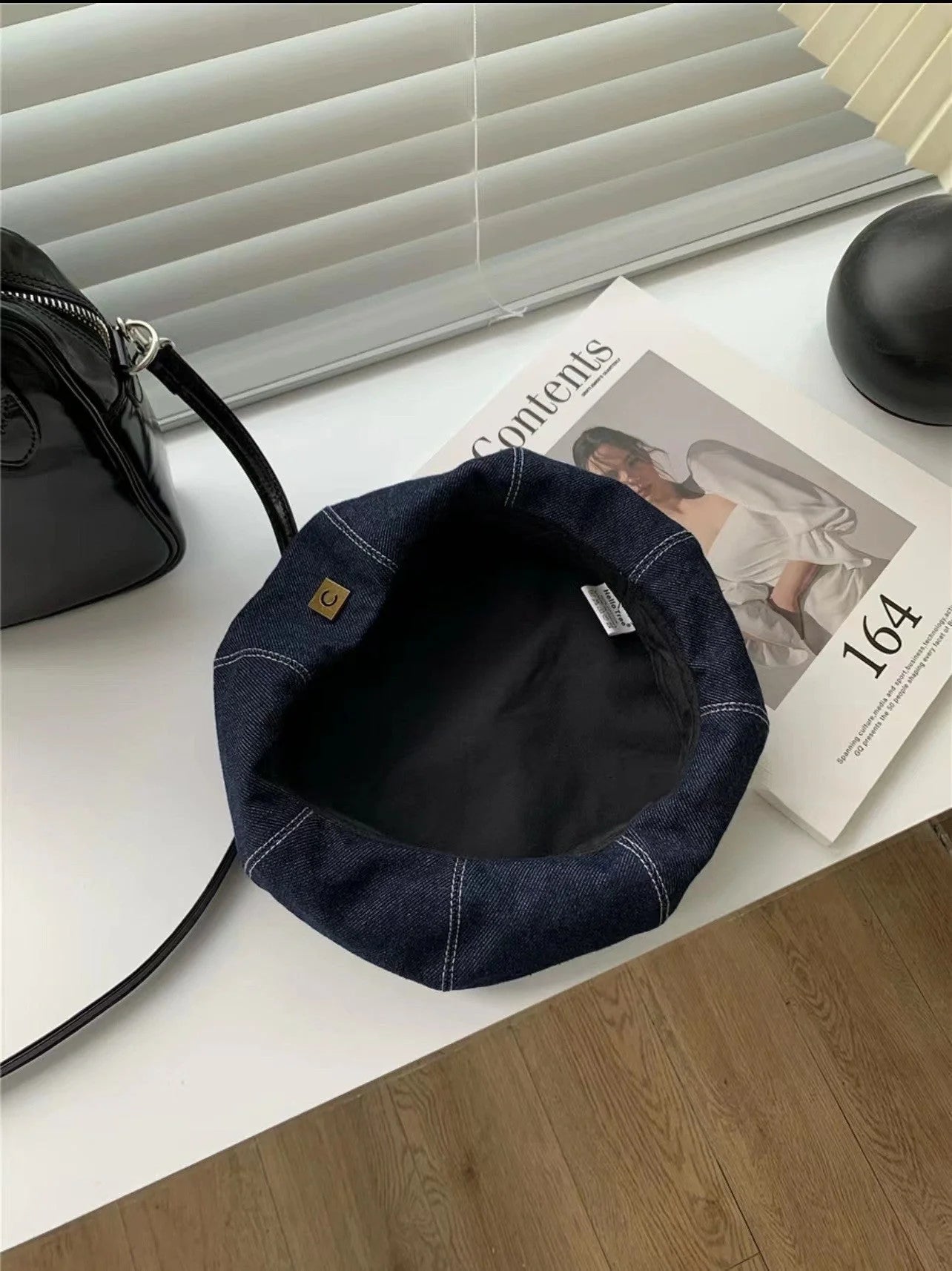 A stylish Japanese-inspired denim beret with a dome-shaped crown and a brimless silhouette, available in light, medium, and dark denim shades.
